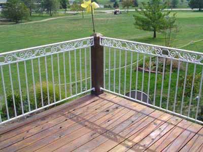 Powdercoated outdoor deck railing with scrollwork mouonted to wood posts